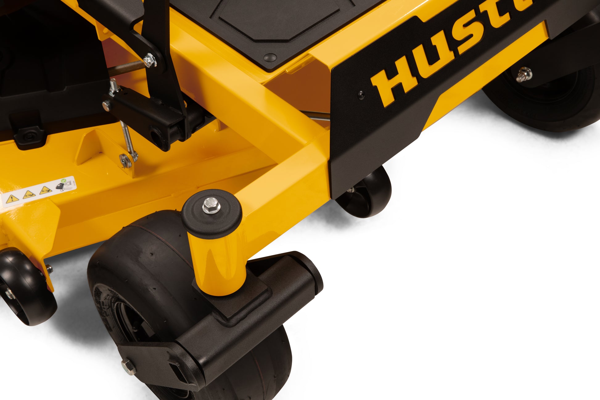 Close-up of a yellow Hustler lawn mower with visible branding on a white background