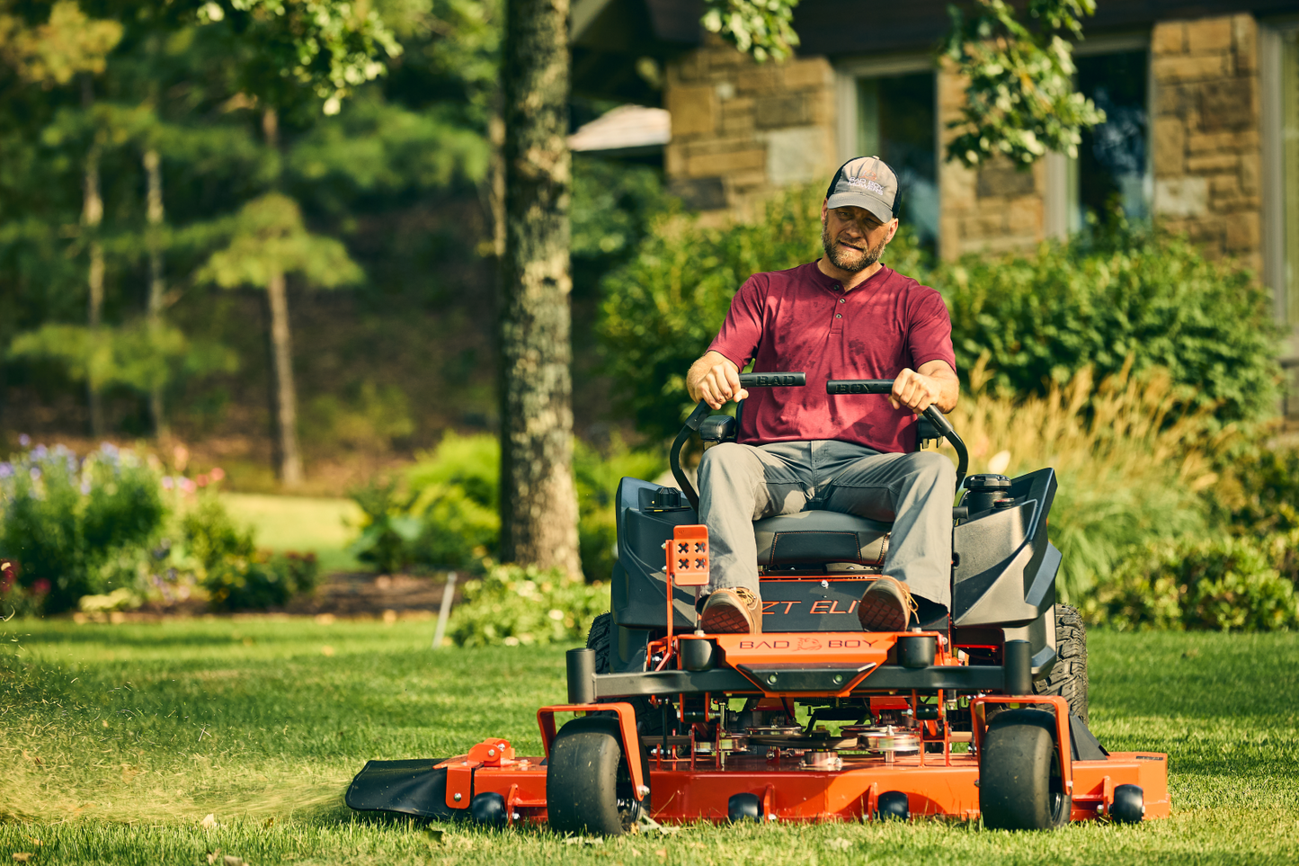 Man operating a riding lawn mower in a garden