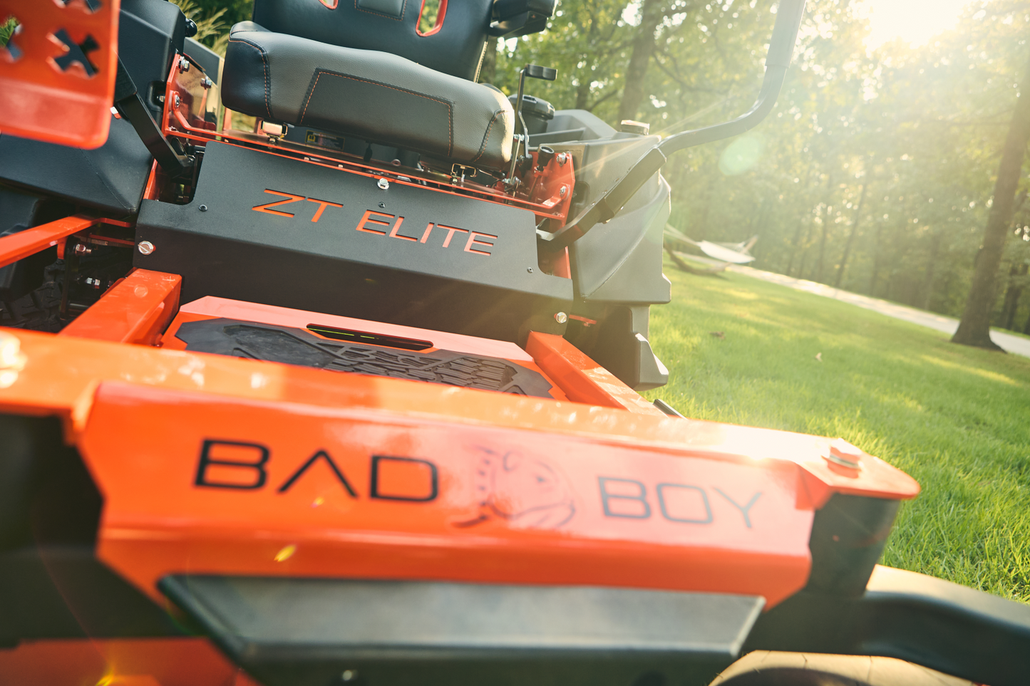 Close-up of a Bad Boy lawn mower with 'ZT Elite' branding in a grassy outdoor setting.