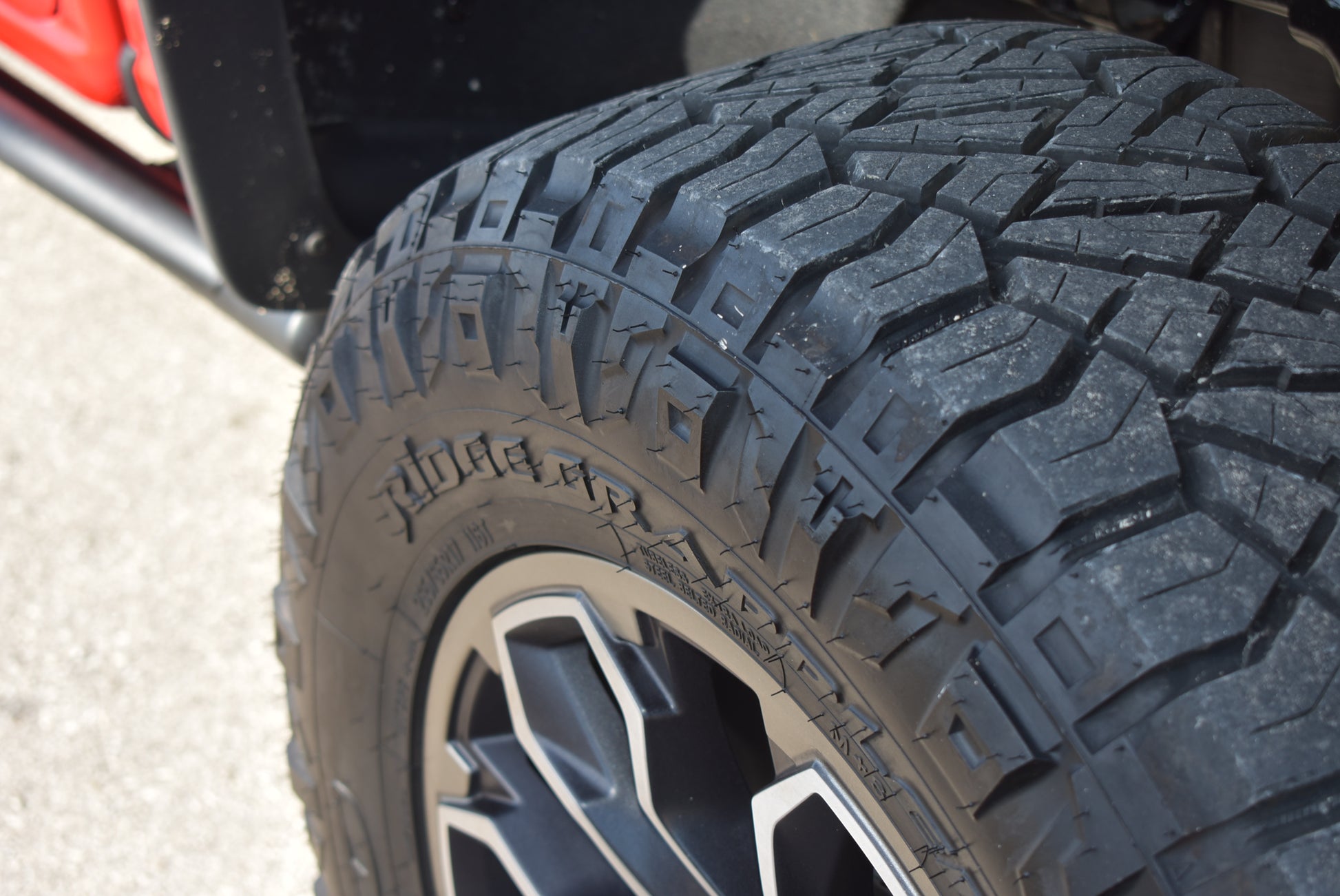 Close-up of a tire with tread pattern on a vehicle