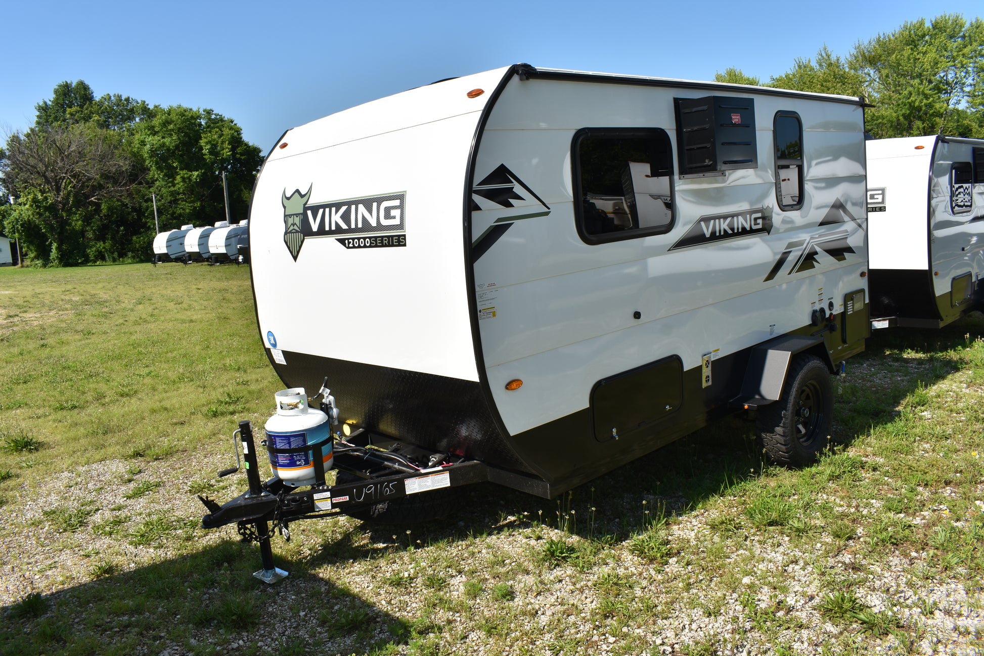 White travel trailer with 'Viking' branding parked on grass