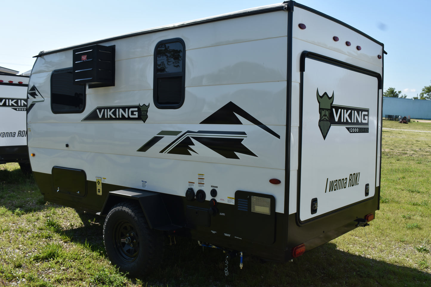 White travel trailer with 'Viking' branding on a grassy field