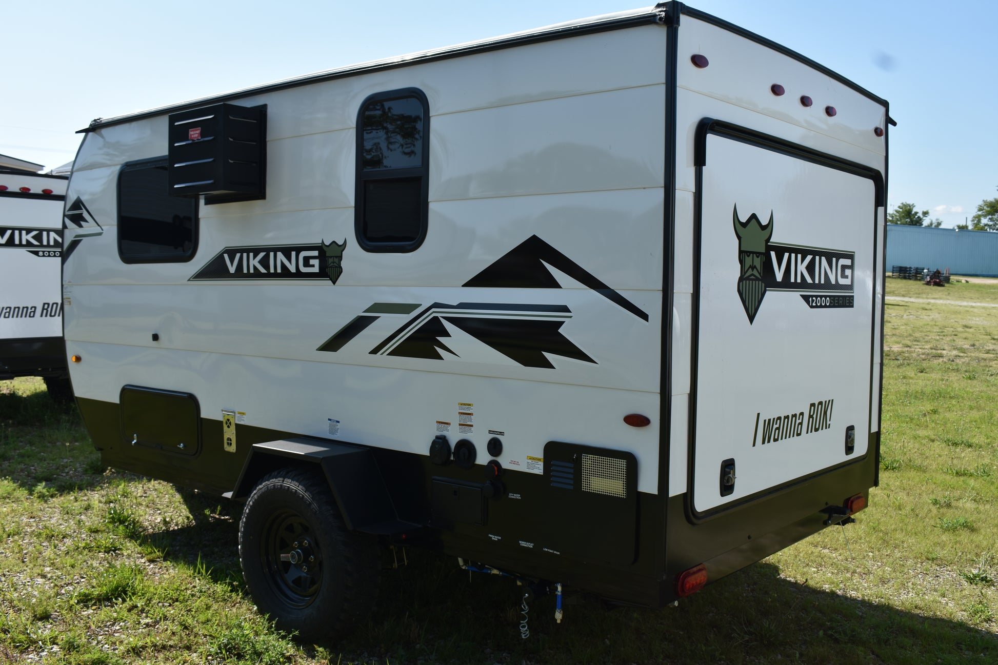 White travel trailer with 'Viking' branding on a grassy field