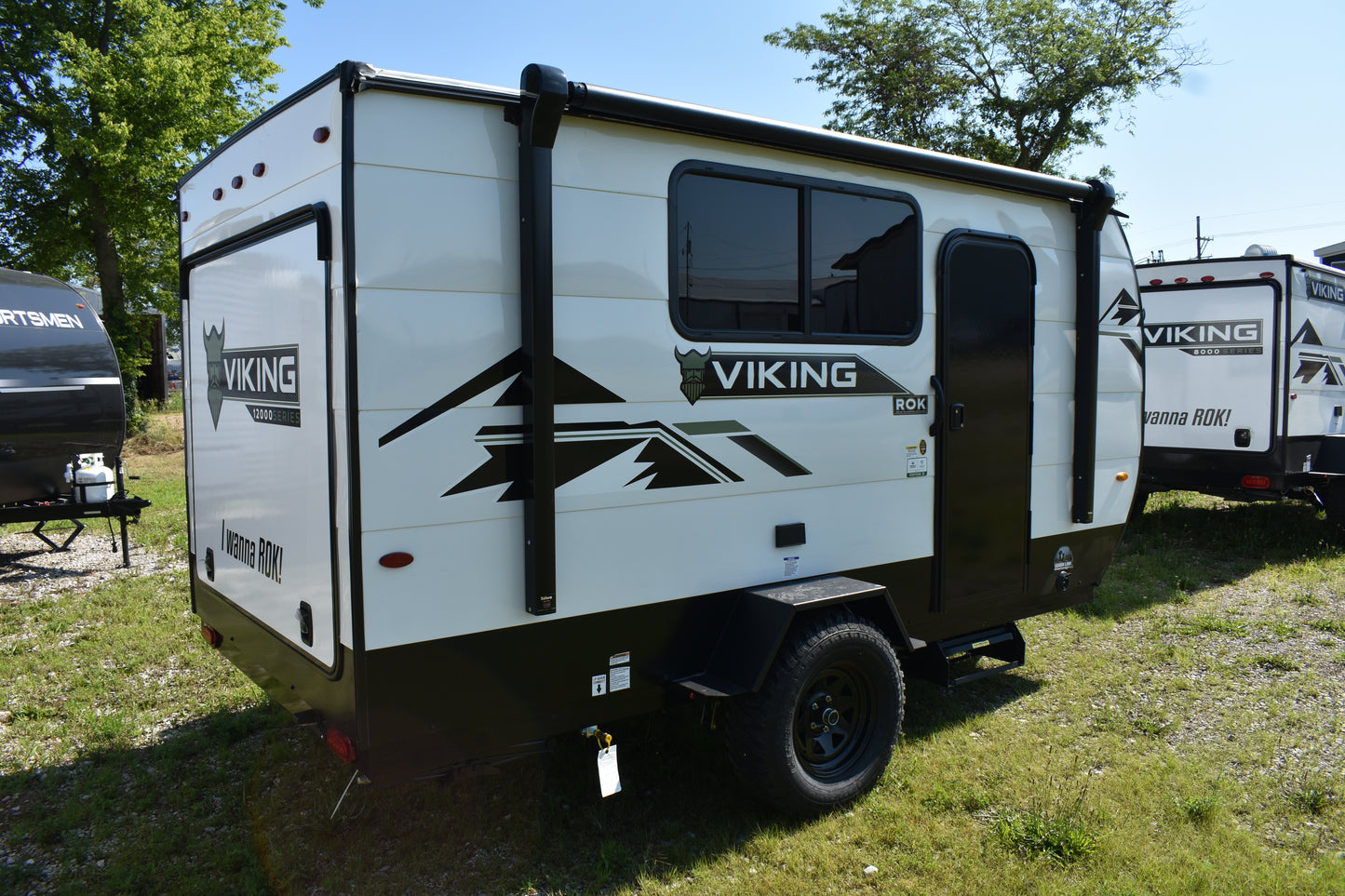 White travel trailer with 'Viking' branding parked on grass