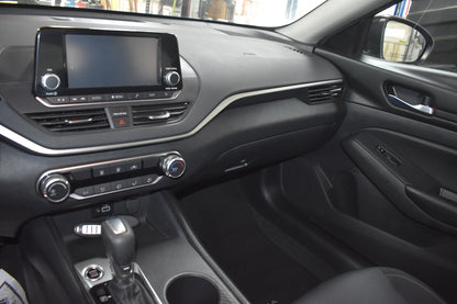 Car interior with dashboard, steering wheel, and center console.