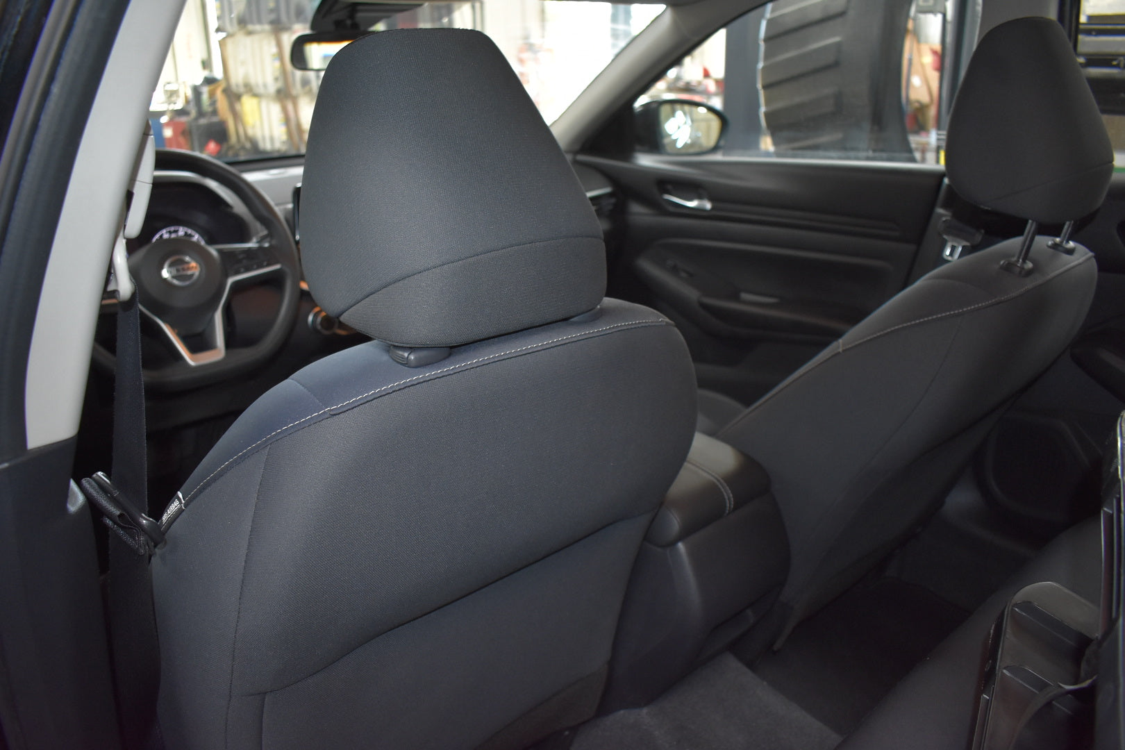Car interior with gray leather seats and dashboard.
