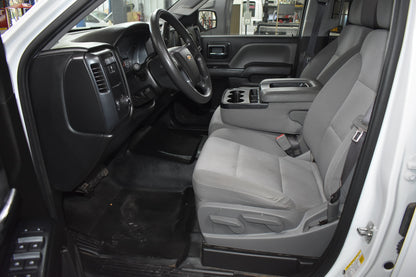 Interior of a vehicle with gray seats and black dashboard.