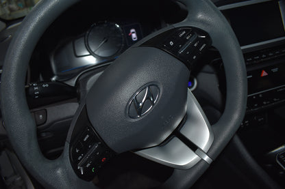 Steering wheel with Hyundai logo in a car interior
