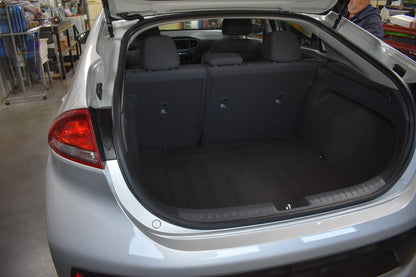 Open trunk of a car with visible interior and cargo space.