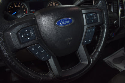 Steering wheel with Ford logo in a vehicle interior