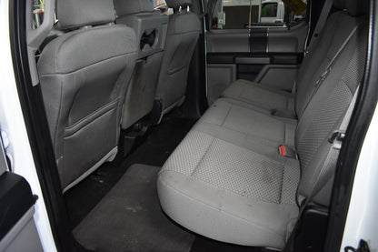Interior of a vehicle showing gray seats and door panels.
