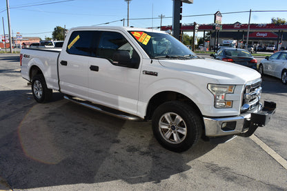 White pickup truck with sale tags in a parking lot