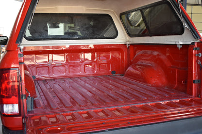 Red pickup truck bed with a white interior