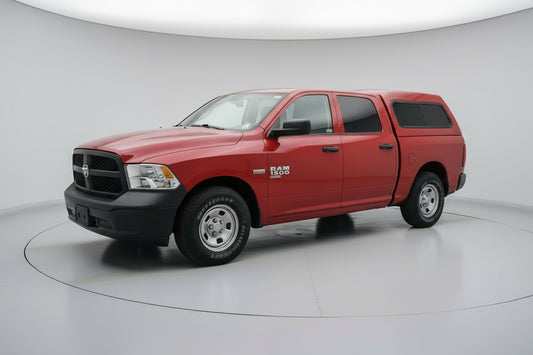 Red pickup truck parked in front of a building with a wreath on the door.