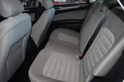 Beige car seats with a visible seat belt in a vehicle interior.