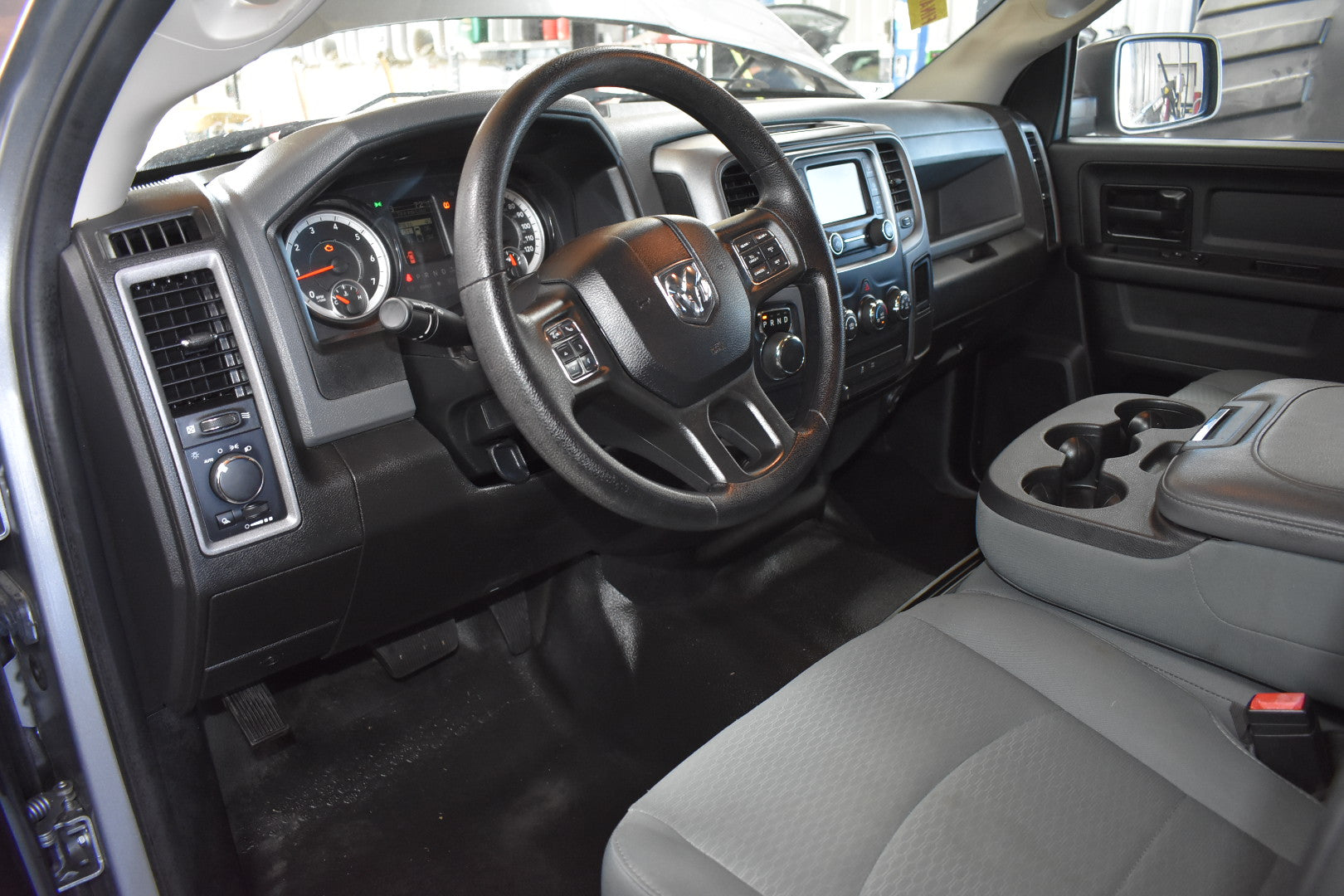 Interior of a vehicle showing dashboard, steering wheel, and seats.