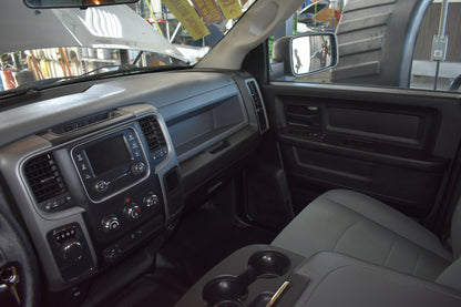 Interior of a vehicle showing dashboard, steering wheel, and passenger seat.
