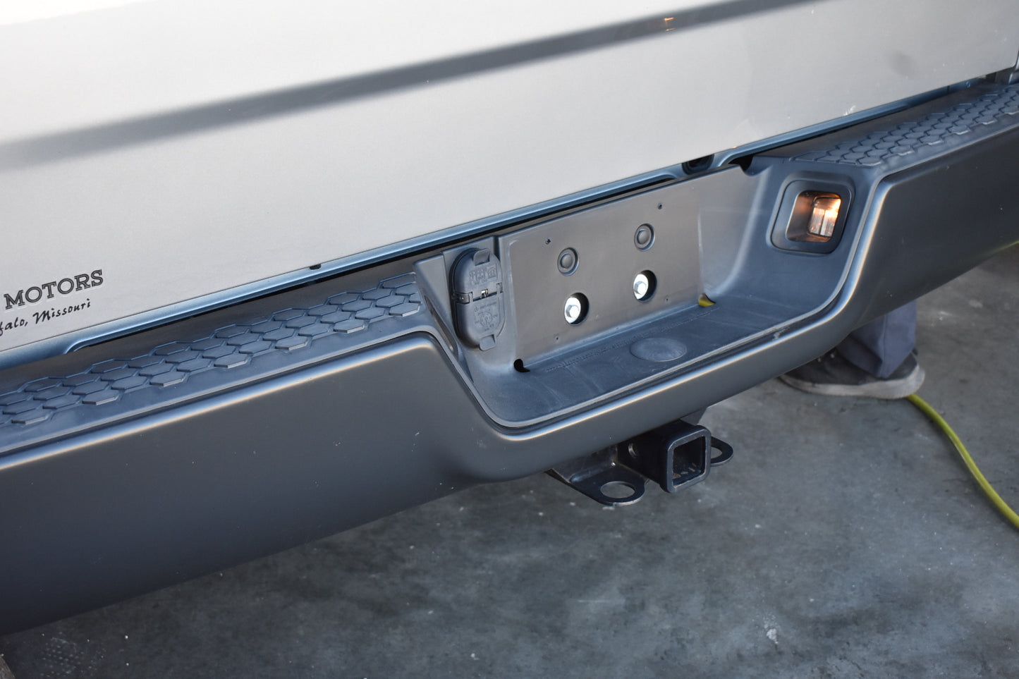 Close-up of a vehicle's hitch receiver on a concrete surface