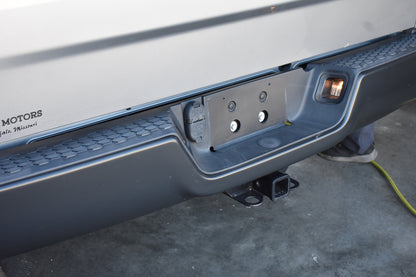 Close-up of a vehicle's hitch receiver on a concrete surface