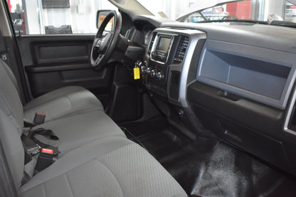 Interior of a vehicle with gray seats and dashboard.