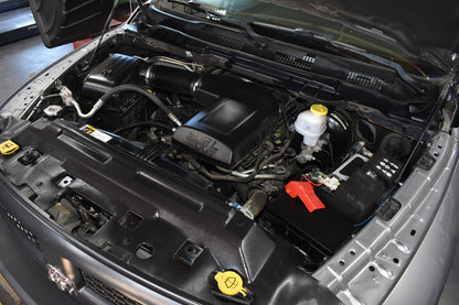 Car engine compartment with various components visible