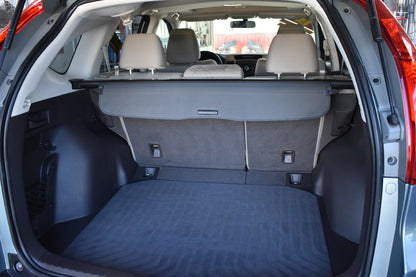 Open car trunk with folded rear seats in a clear background