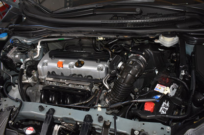 Car engine compartment with various components visible