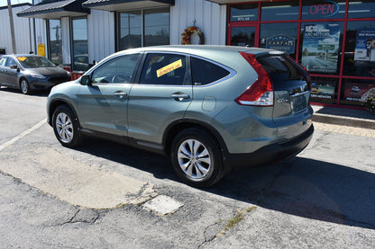 Silver SUV parked in front of a car dealership