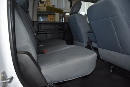 Gray car interior with open door showing backseat and cargo area.