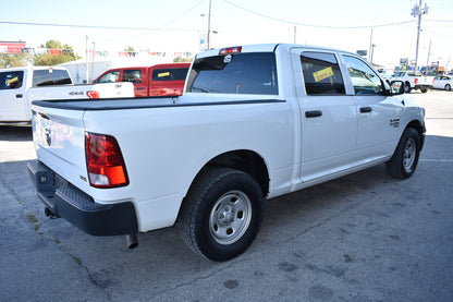 White pickup truck parked in a lot with other vehicles in the background