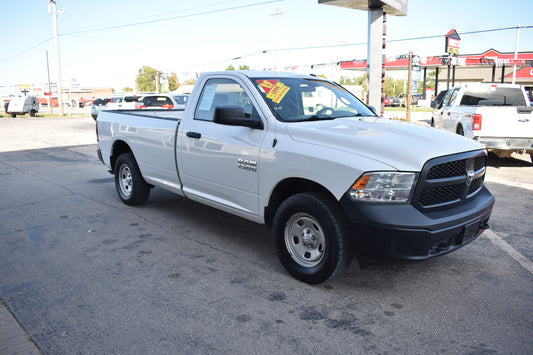 White pickup truck with a sale tag on a gas station lot