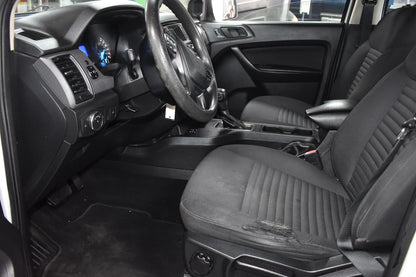 Interior of a vehicle with black leather seats and dashboard.