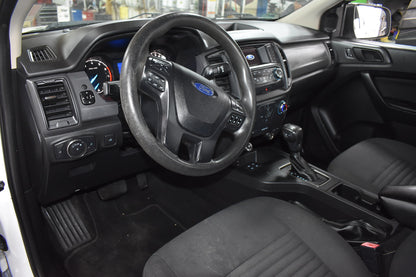Car interior with steering wheel and dashboard in a showroom setting