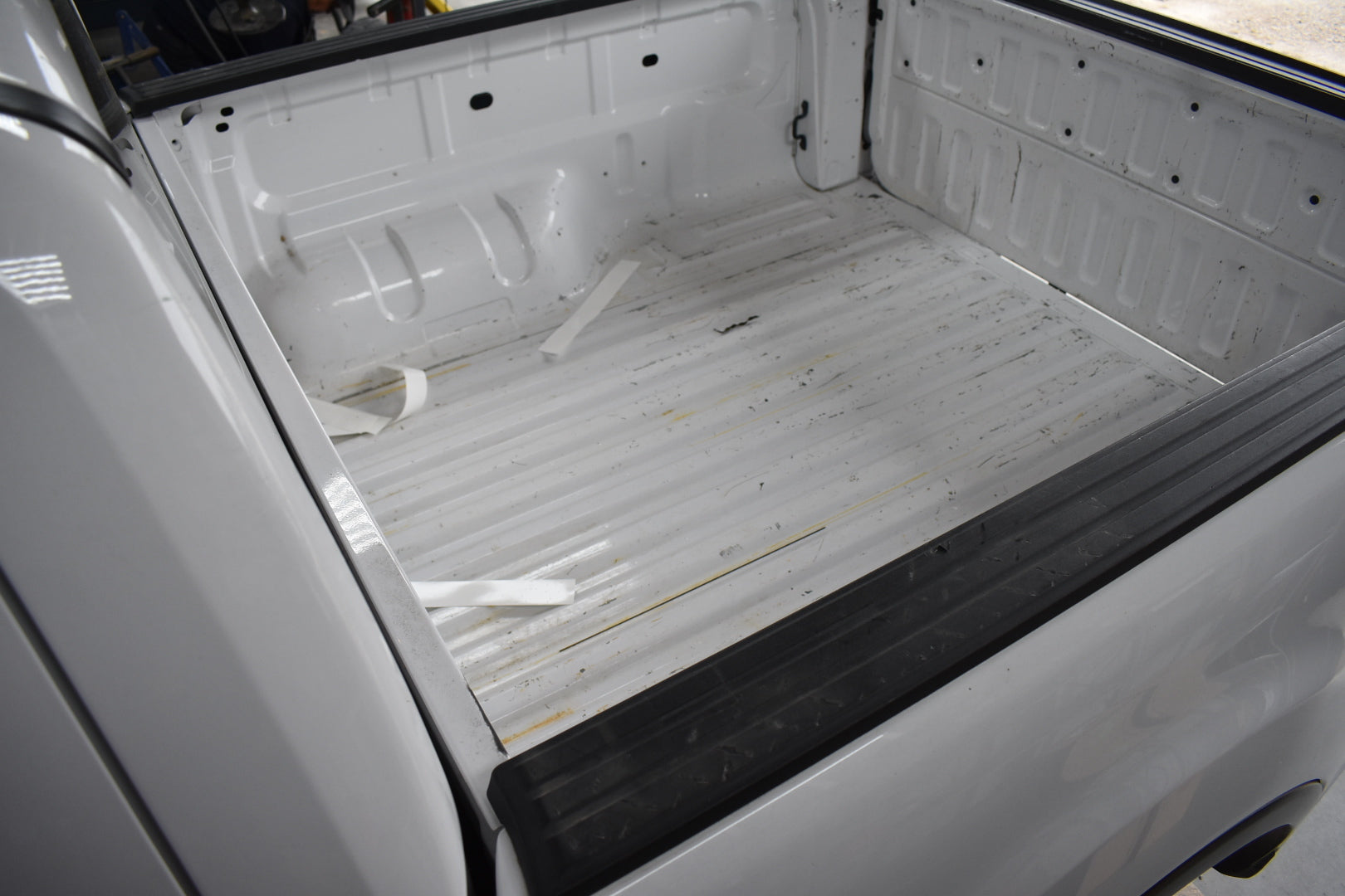 Empty truck bed with a white liner