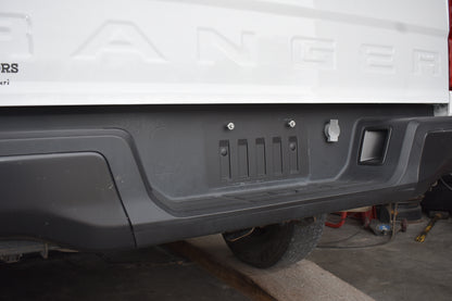Close-up of a vehicle's rear bumper with 'Ford' branding.