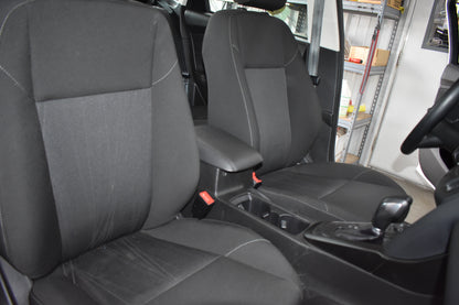 Gray car seats inside a vehicle with a blurred background