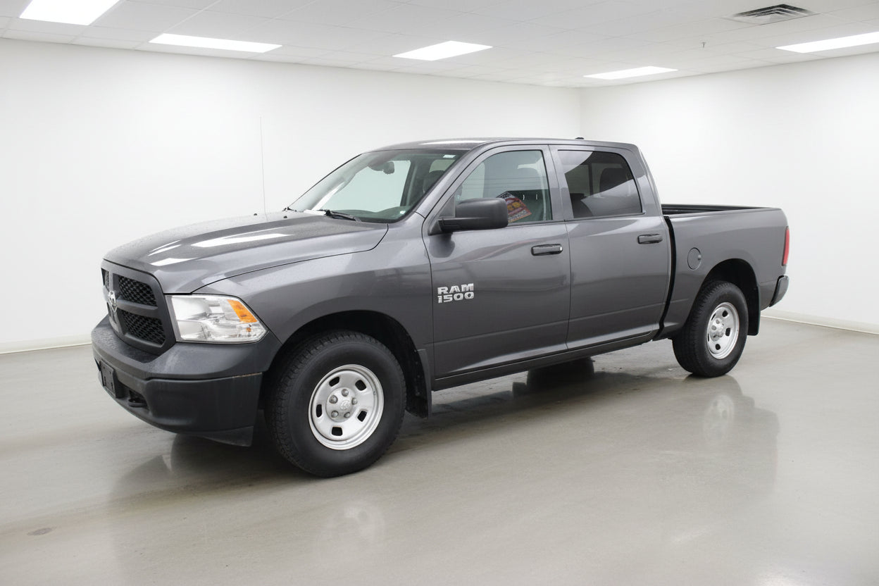 Gray Ram truck parked in front of a building sold at abc motors in buffalo