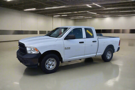 White pickup truck parked outside a car repair shop with 'ABC Motors' branding.