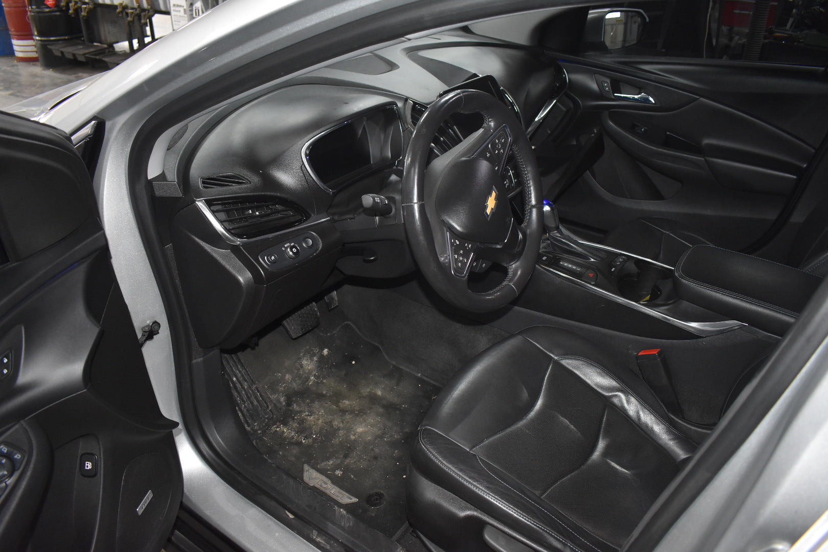 Car interior with steering wheel and dashboard visible