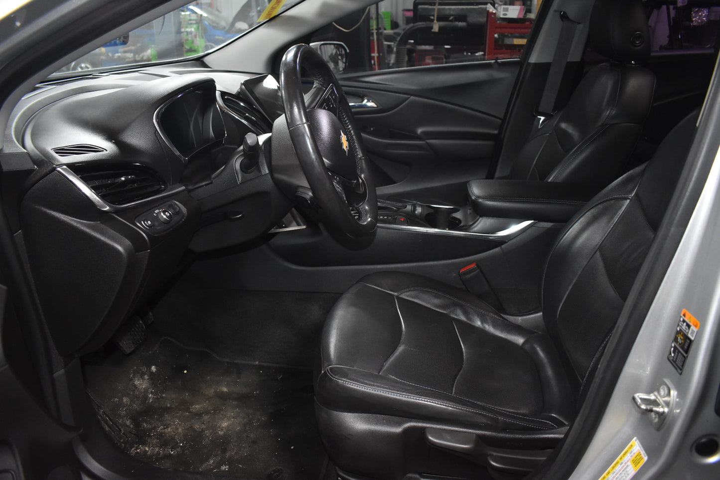 Interior of a car with a focus on the steering wheel and dashboard.