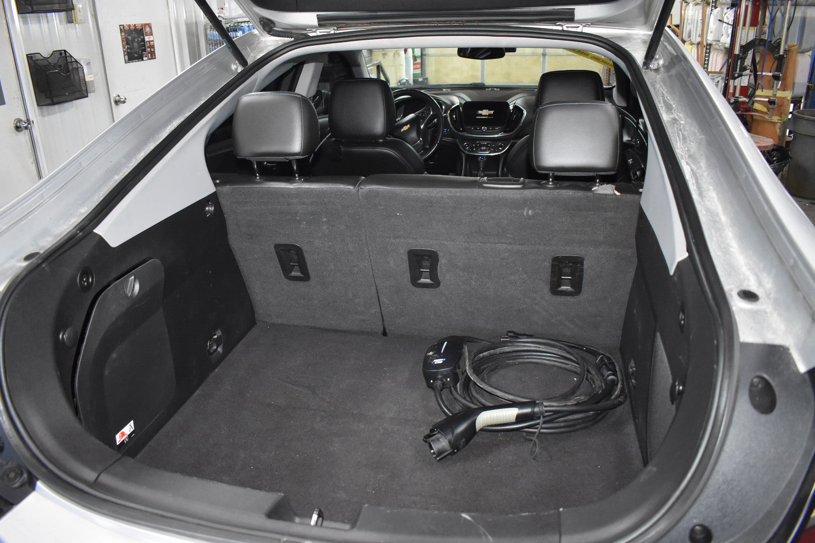 Car trunk with charging cable and car seat covers inside