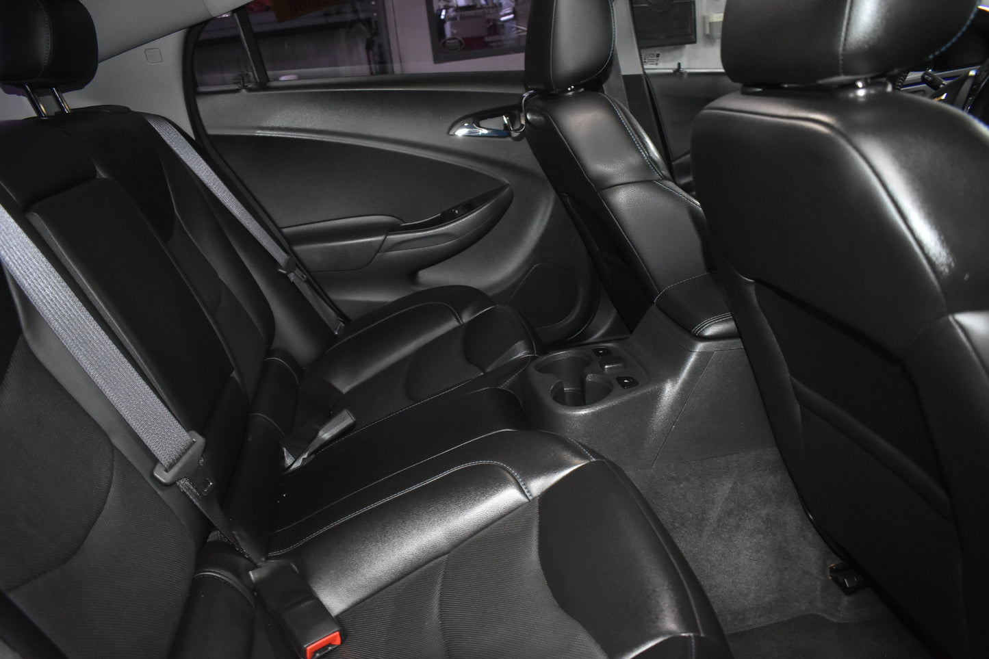Back seat interior of a car with black leather seats.