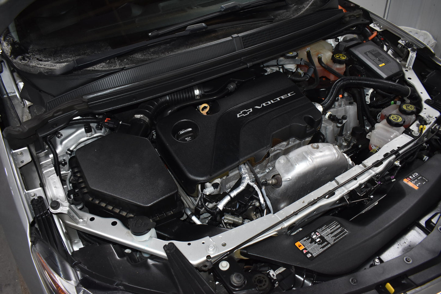 Car engine with Volvo logo open hood