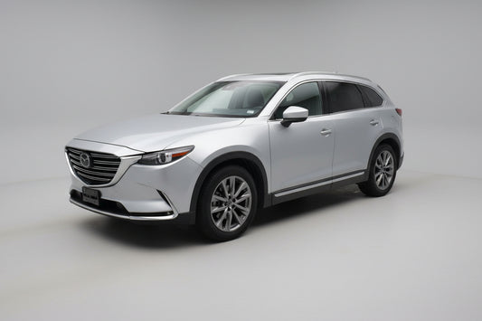 Silver SUV parked in front of a building with a red and white exterior.