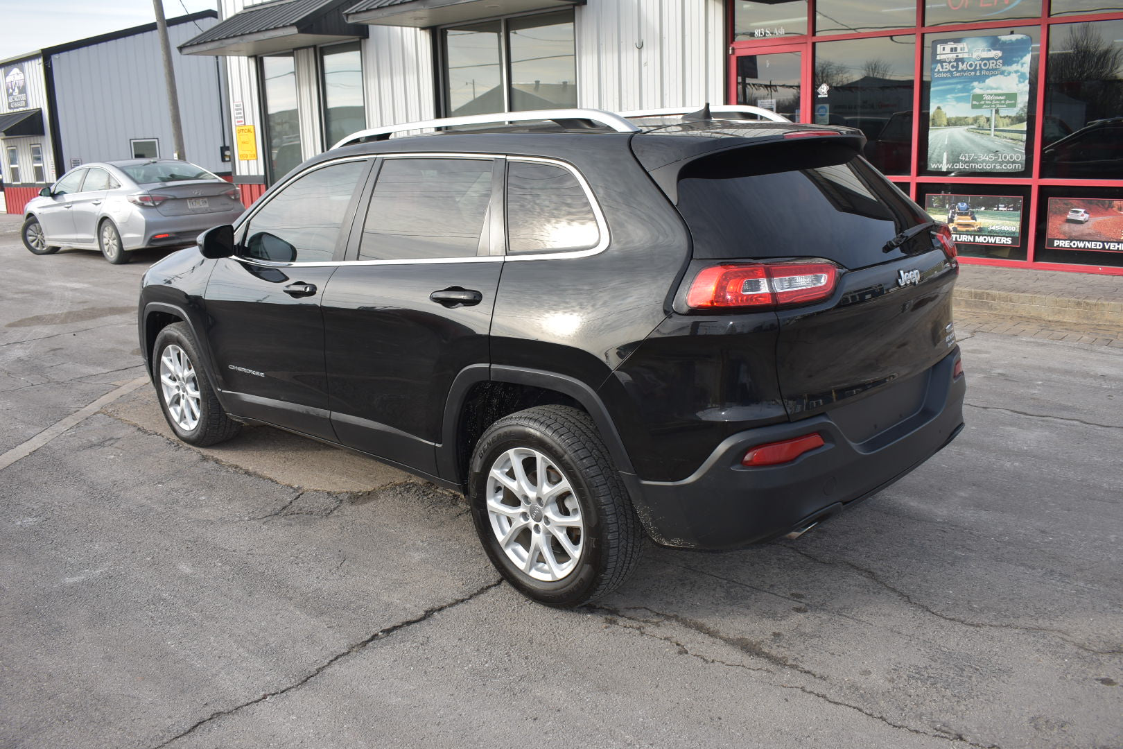 Black SUV parked in a lot with a building in the background