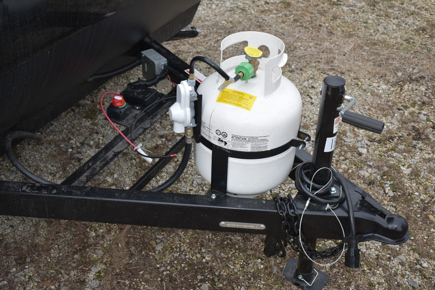 Towing hitch with propane tank attachment on a textured surface
