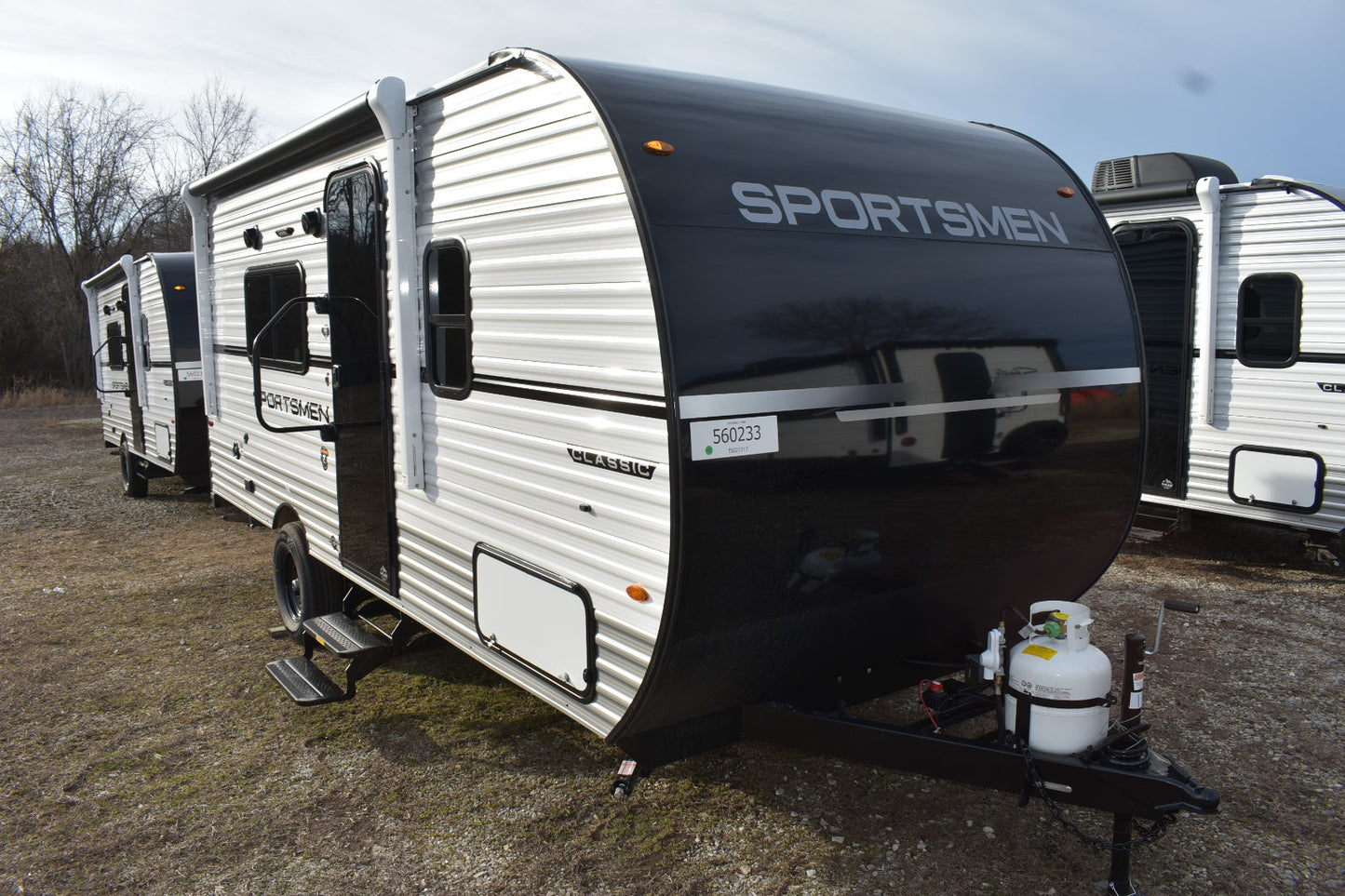 Line of travel trailers with a prominent 'Sportsmen' model in the foreground.
