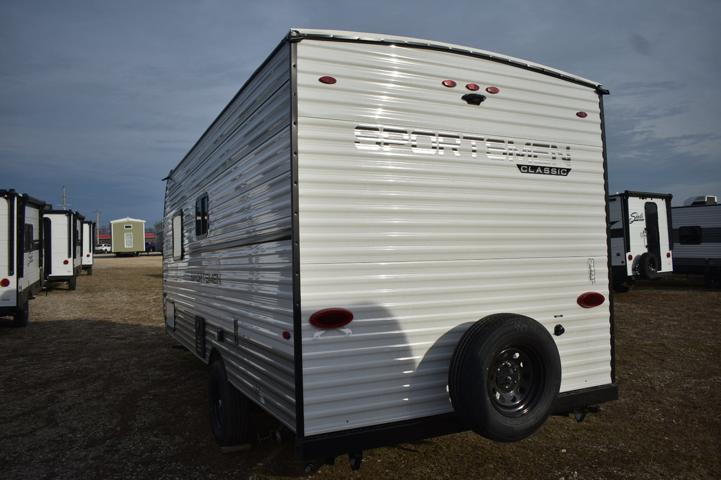 White travel trailer with visible branding in an outdoor setting