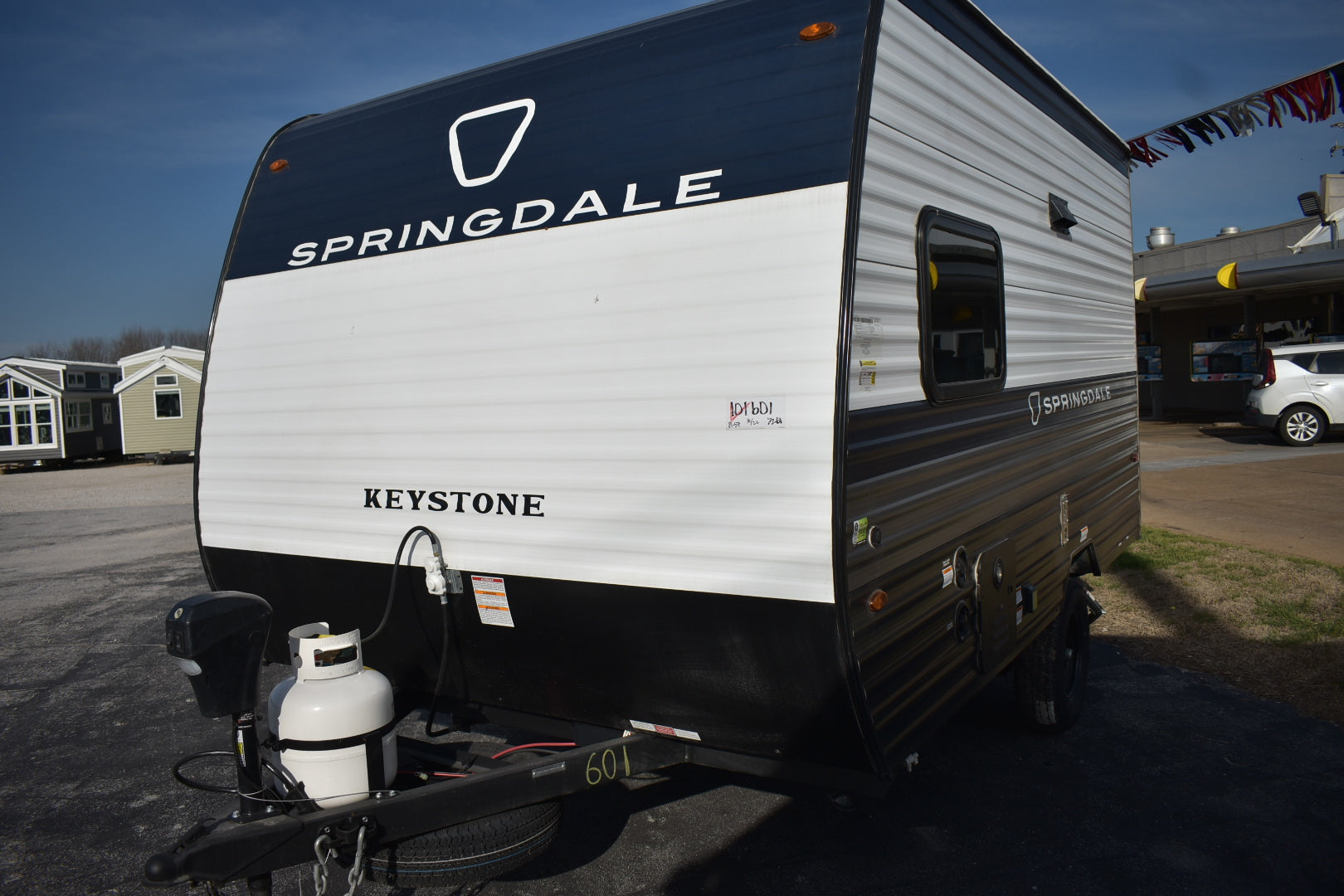 Springdale Keystone travel trailer parked outdoors with clear sky