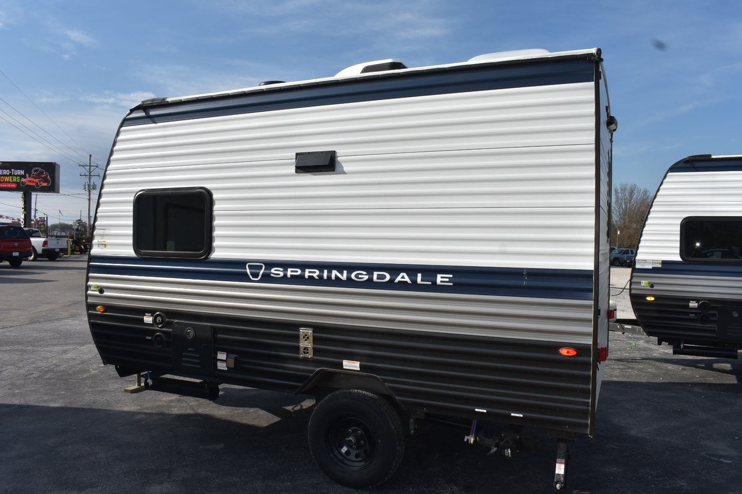Springdale travel trailer parked in a lot with clear sky